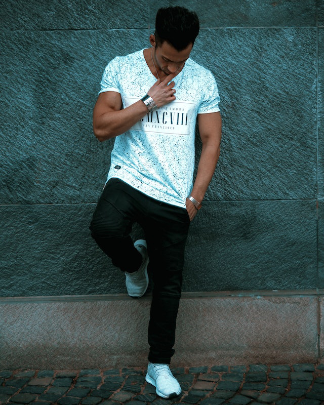 A young man standing with white t shirt
